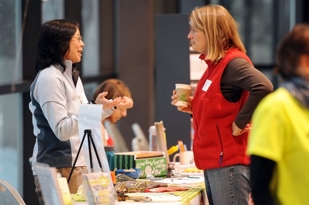 Faye Ogaswara of Slow Food Huron Valley and Carole Durgy of Project Health Schools/UMHS chat during the Homegrown Local Food Summit in the atrium at the Morris J. Lawrence Building at Washtenaw Community College on Friday, Feb. 22, 2013. Melanie Maxwell I AnnArbor.com